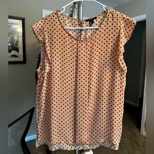 Short sleeve blouse. Color is a light peach color with navy polkadots.